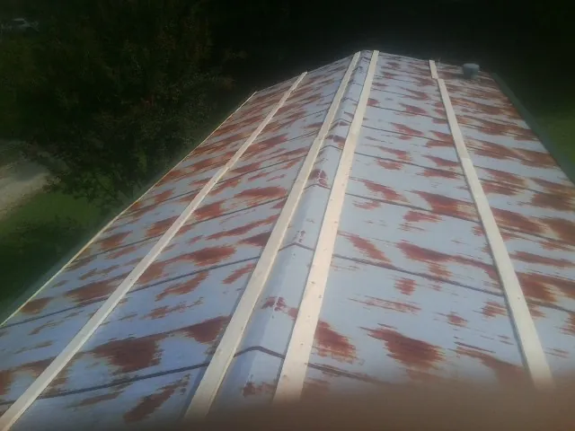 Rusted metal roof panels with new wood purlins before replacement — Storm Damage Roof Repair in Joshua by Roofing Brothers